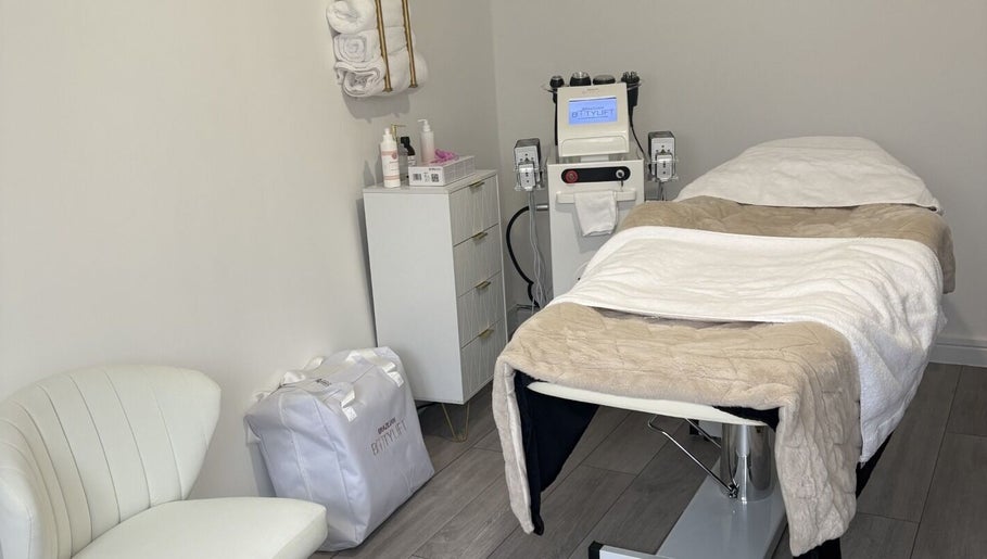Relaxing treatment room at Sculpted By Hayley, Winchester, England, GB with massage bed and equipment.