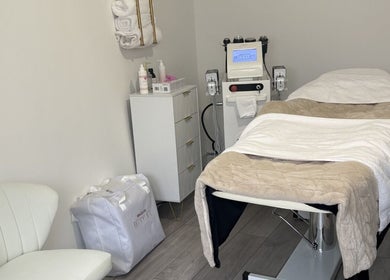 Relaxing treatment room at Sculpted By Hayley, Winchester, England, GB with massage bed and equipment.