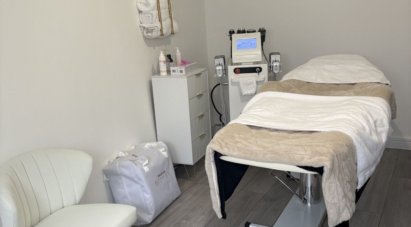 Relaxing treatment room at Sculpted By Hayley, Winchester, England, GB with massage bed and equipment.