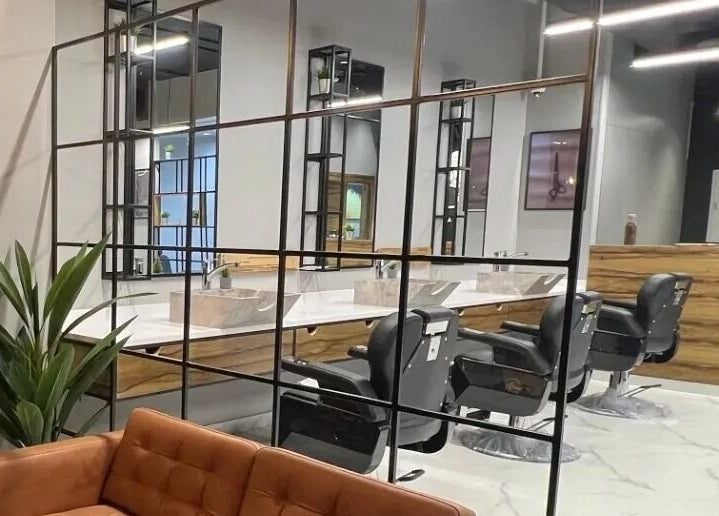 Modern interior of Yousef Afandi - Ghirnatah I يوسف أفندي - غرناطة in Riyadh, featuring stylish salon chairs and mirrors.