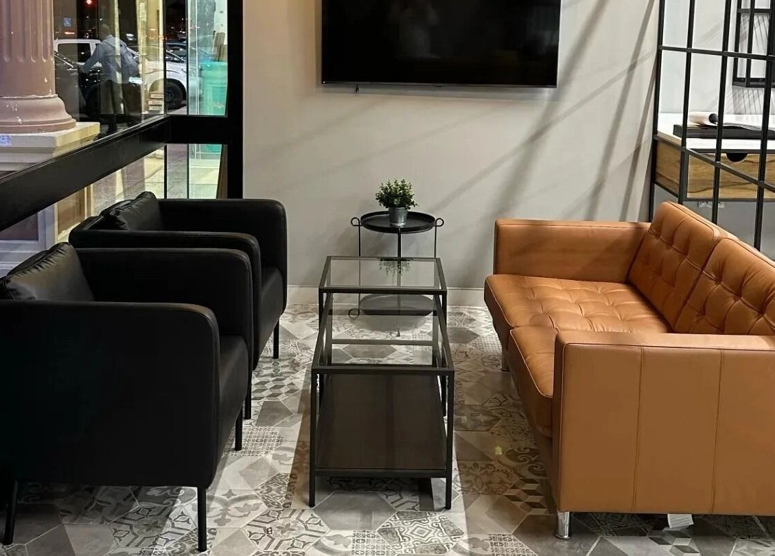 Modern seating area at Yousef Afandi - Ghirnatah I يوسف أفندي - غرناطة, Riyadh, with black and tan sofas.