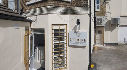 Entrance to Citrine Clinic in Ilford, England, GB with signage and open door.