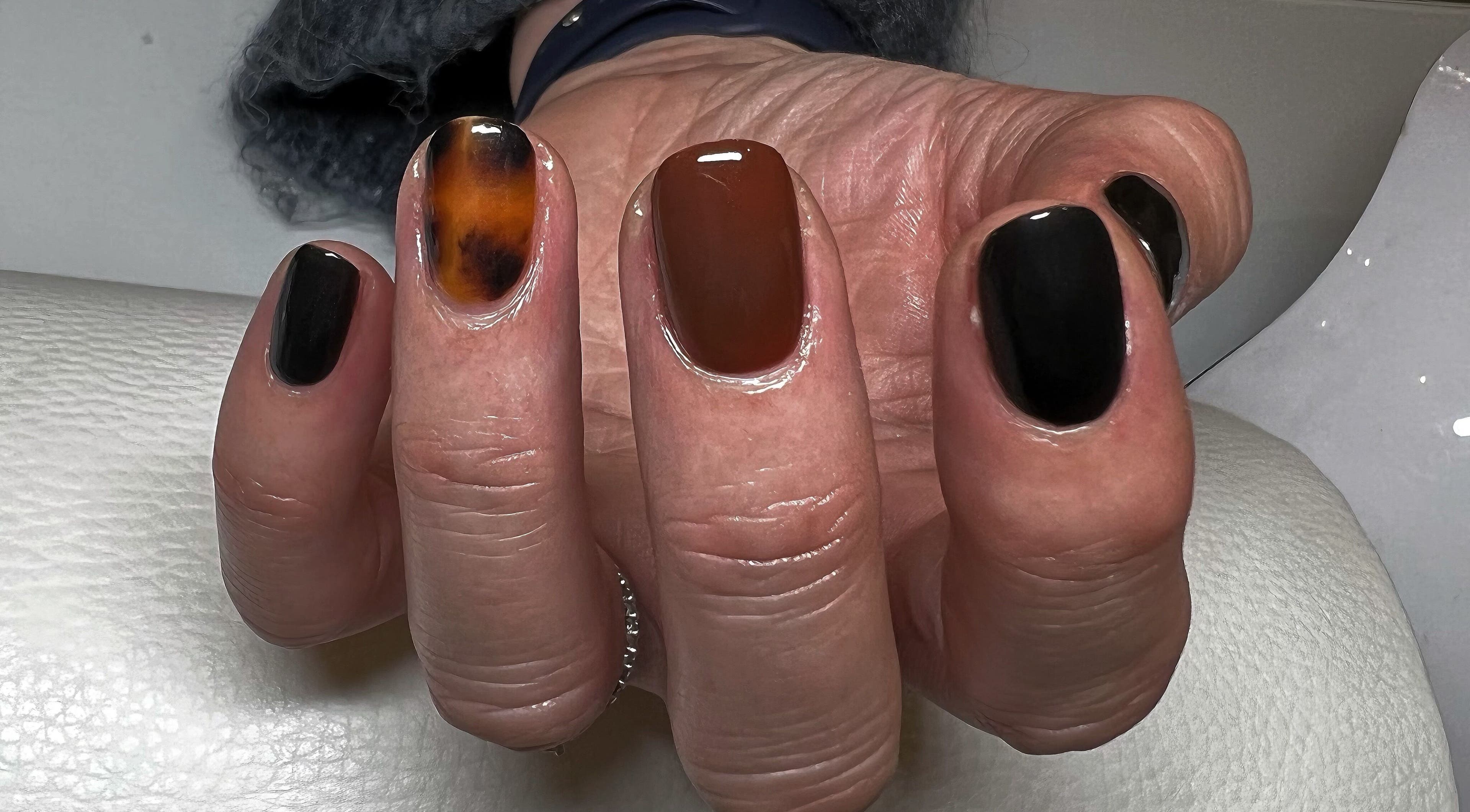 Stylish brown and black nail design at Kerisbeauty in Swindon, England, GB.