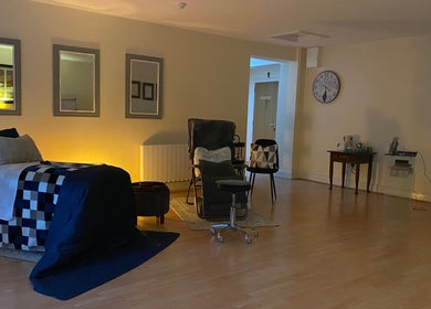 Tranquil therapy room at Celestial Blessings Therapy, Newport, County Tipperary, IE with cozy seating and decor.