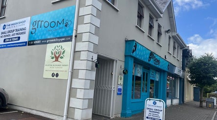 Exterior view of Celestial Blessings Therapy in Newport, County Tipperary, IE with vibrant storefronts.