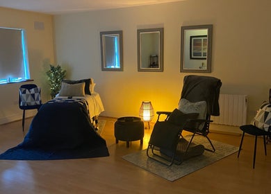 Relaxing therapy room at Celestial Blessings Therapy, Newport, County Tipperary, IE with warm lighting and cozy decor.