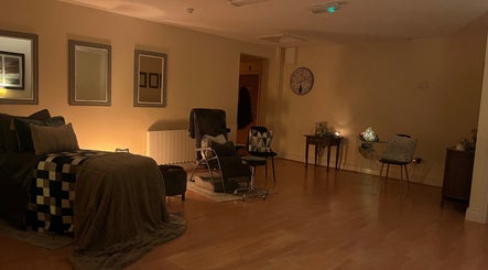 Relaxing therapy room at Celestial Blessings Therapy in Newport, County Tipperary, IE, featuring cozy chairs and soft lighting.