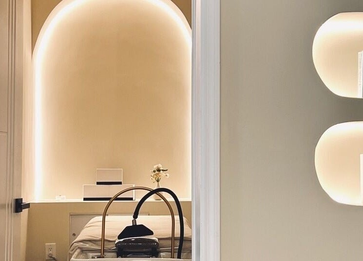 Tranquil treatment room at SENA, New York, New York, US, featuring ambient lighting and relaxing decor.