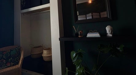 Tranquil interior of Beauty Rituals by Abbey in Abergavenny, Wales, GB with wicker chair and decor.