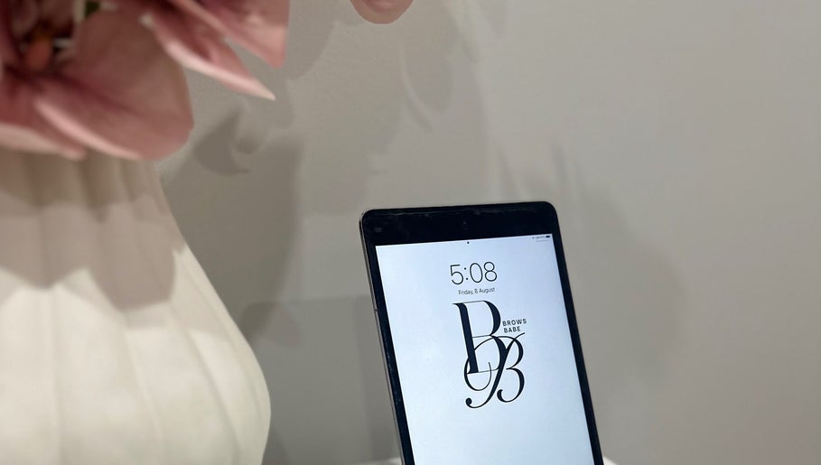 Tablet displaying BROWS BABE logo at Melbourne, Victoria, AU beauty venue.