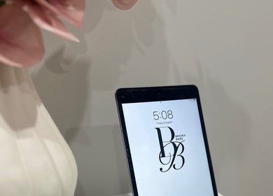 Tablet displaying BROWS BABE logo at Melbourne, Victoria, AU beauty venue.