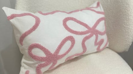 Cushion with pink textured design at BROWS BABE, Melbourne, Victoria, AU enhances relaxation vibe.