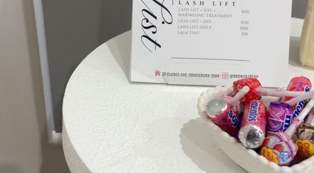 Candy bowl and lash lift menu at BROWS BABE in Melbourne, Victoria, AU. Lash services and sweet treats offered.