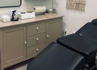 Luxury treatment room at The Sugar Lounge, St. Thomas, Ontario, CA with a sleek massage table and essentials.