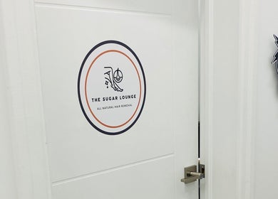 Entrance of The Sugar Lounge in St. Thomas, Ontario, CA with logo sign on the door.