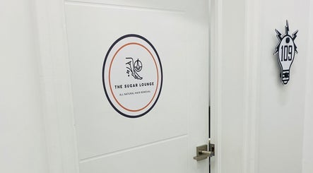 Entrance of The Sugar Lounge in St. Thomas, Ontario, CA with logo sign on the door.