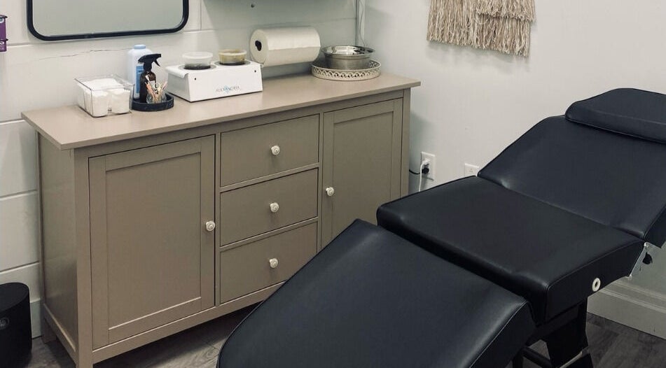 Comfortable treatment room at The Sugar Lounge in St. Thomas, Ontario, CA with massage bed and sleek decor.