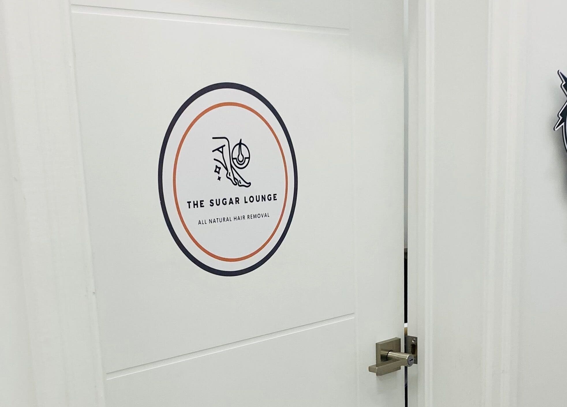 Entrance to The Sugar Lounge in St. Thomas, Ontario, CA showcasing stylish door with logo.