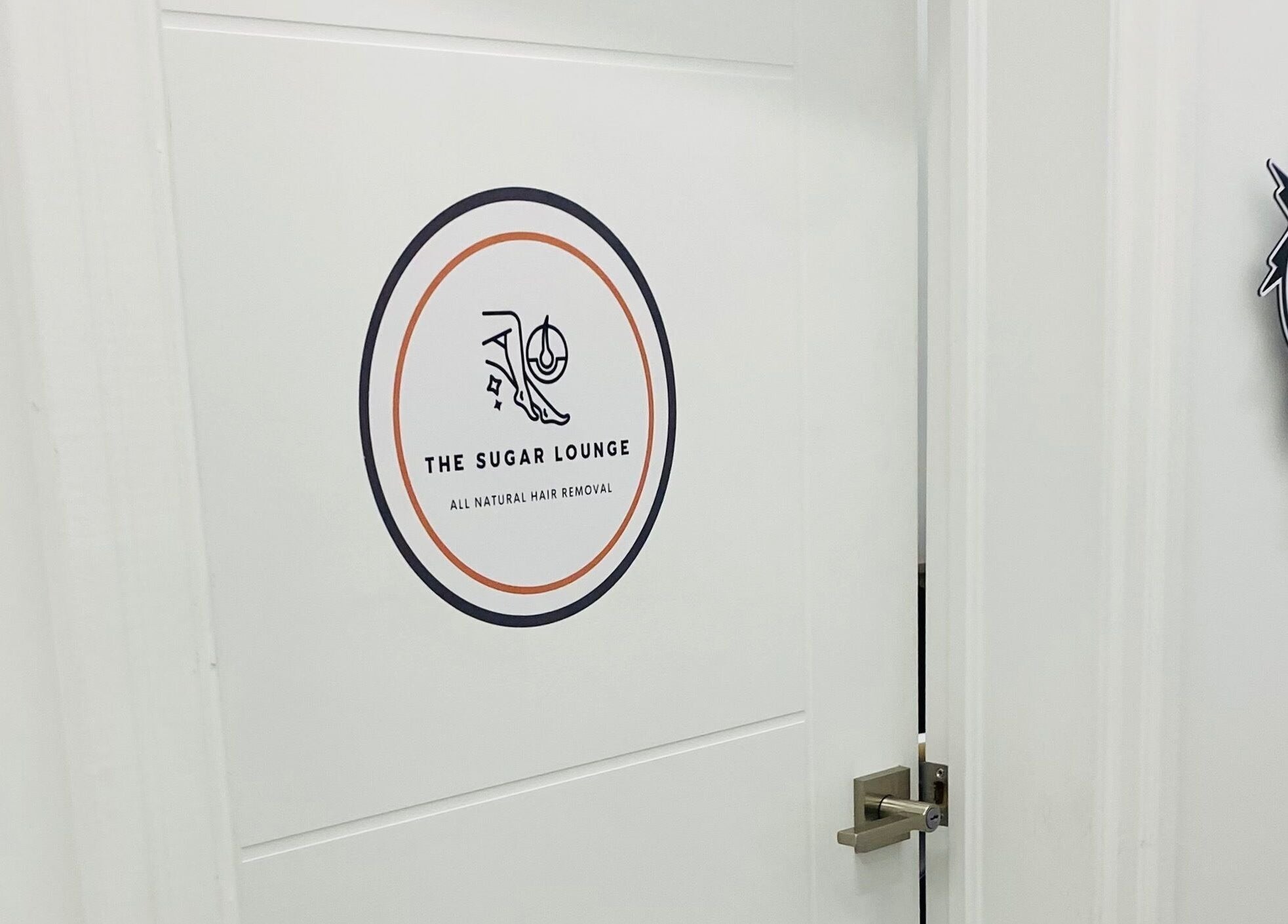 Entrance to The Sugar Lounge in St. Thomas, Ontario, CA showcasing stylish door with logo.