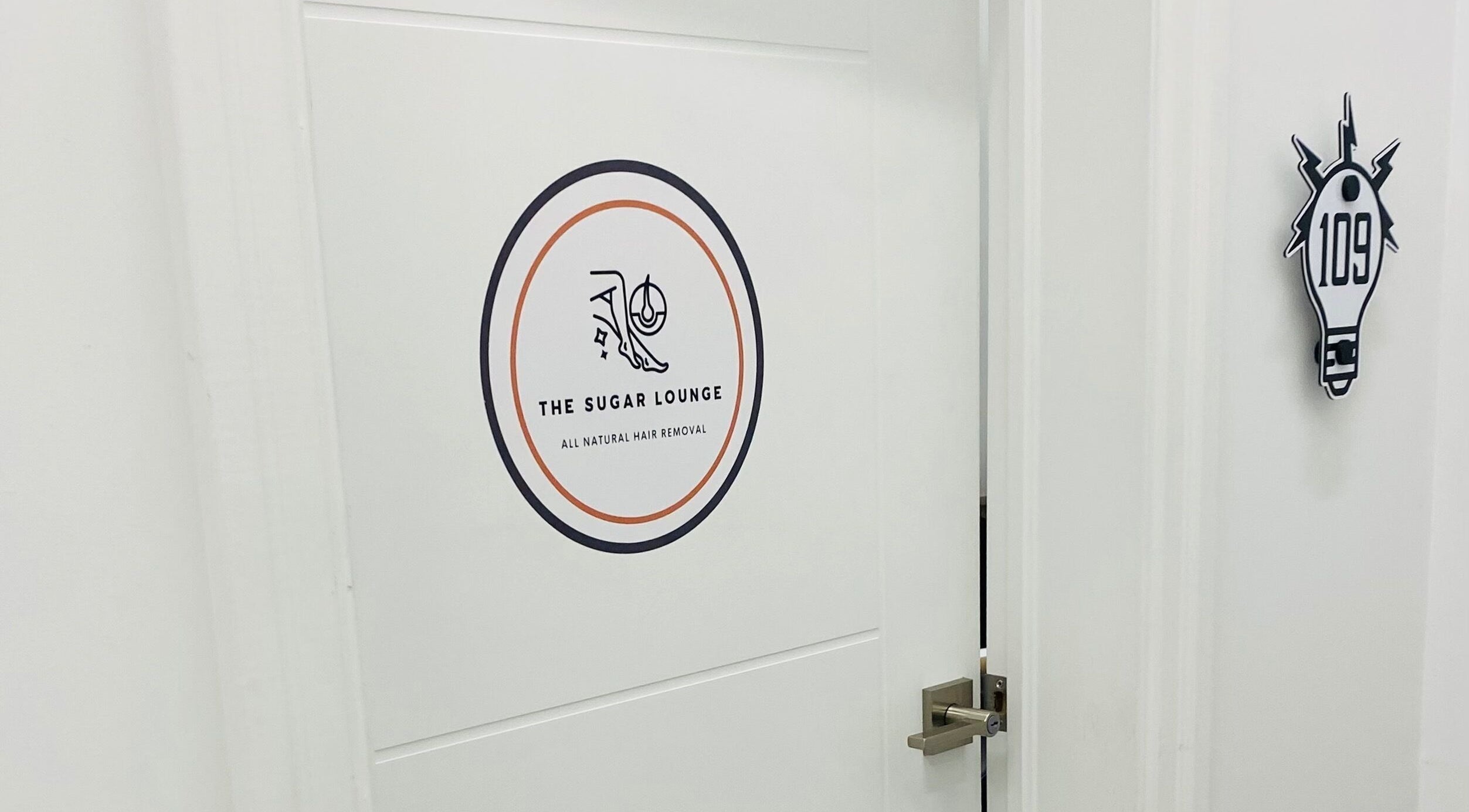 Entrance to The Sugar Lounge in St. Thomas, Ontario, CA showcasing stylish door with logo.