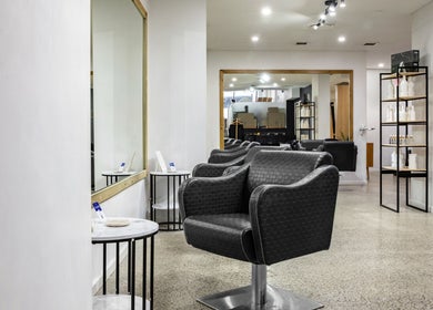 Sleek salon chairs and mirrors at BKT BEAUTY, Sydney, NSW, AU, showcasing modern elegance in a wellness setting.