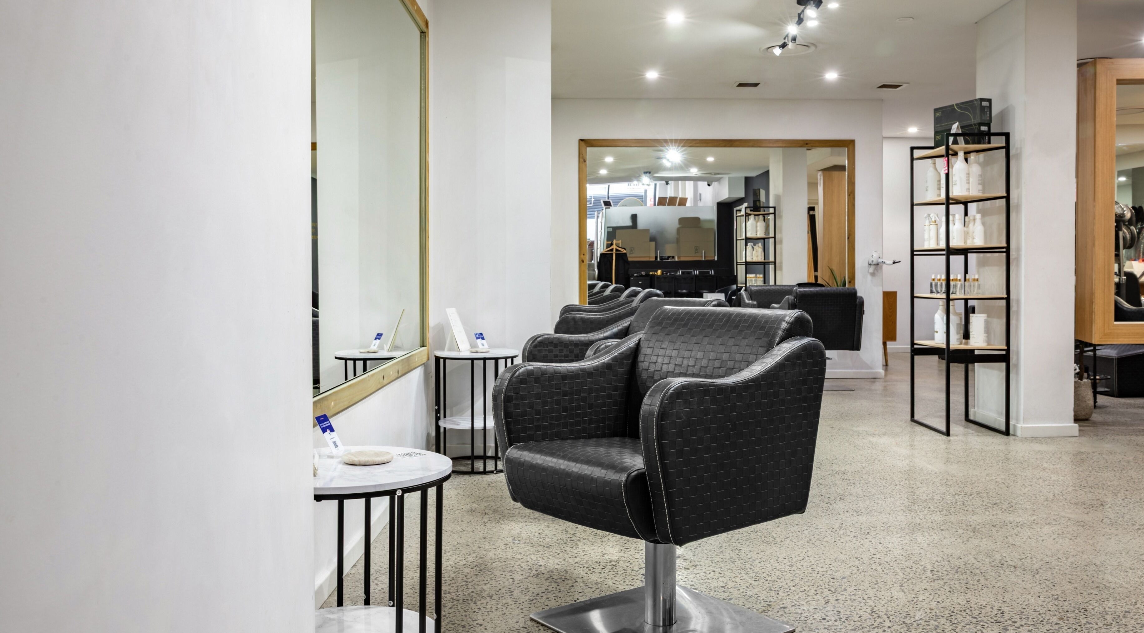 Sleek salon chairs and mirrors at BKT BEAUTY, Sydney, NSW, AU, showcasing modern elegance in a wellness setting.