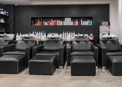 Chic black salon chairs and wash stations at BKT BEAUTY, Sydney, NSW, AU, showcasing modern styling.