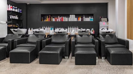 Chic black salon chairs and wash stations at BKT BEAUTY, Sydney, NSW, AU, showcasing modern styling.
