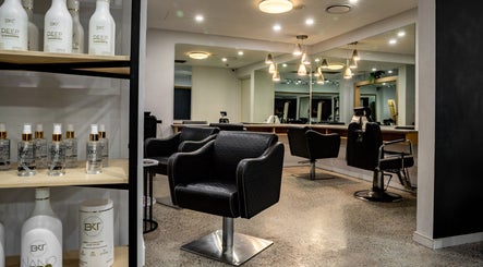 Elegant salon interior at BKT BEAUTY in Sydney, NSW, AU featuring luxury chairs and hair products.