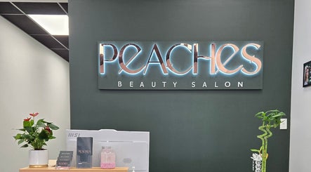 Reception at Peaches Beauty Salon in Timaru, Canterbury Region, NZ with glowing signage and plants.