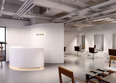 Sophisticated interior of LEEKAJA Tangs Plaza, Singapore, featuring modern beauty stations and a sleek reception.