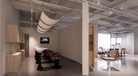 Modern salon interior of LEEKAJA Tangs Plaza in Singapore, showcasing stylish chairs and serene ambiance.