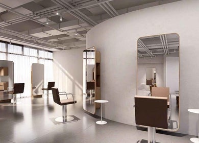 Modern salon interior at LEEKAJA Tangs Plaza, Singapore, Singapore, SG, featuring stylish chairs and mirrors.