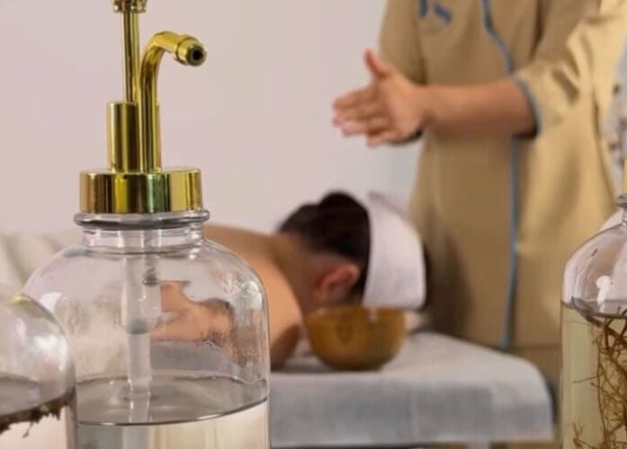 Spa treatment at SYS Beauty Lounge, Dubai, Dubai, AE. Massage setup with oils and a relaxing ambiance.