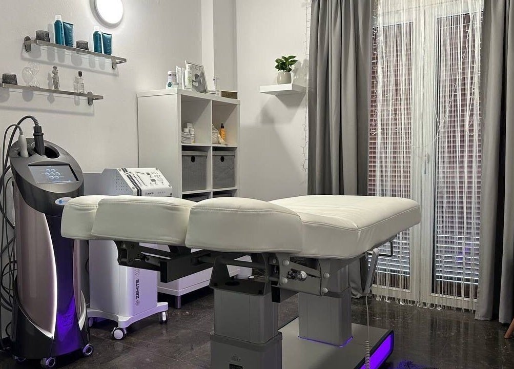 Modern treatment room at GRACE body&face, Glyfada, GR featuring a sleek massage bed and professional equipment.
