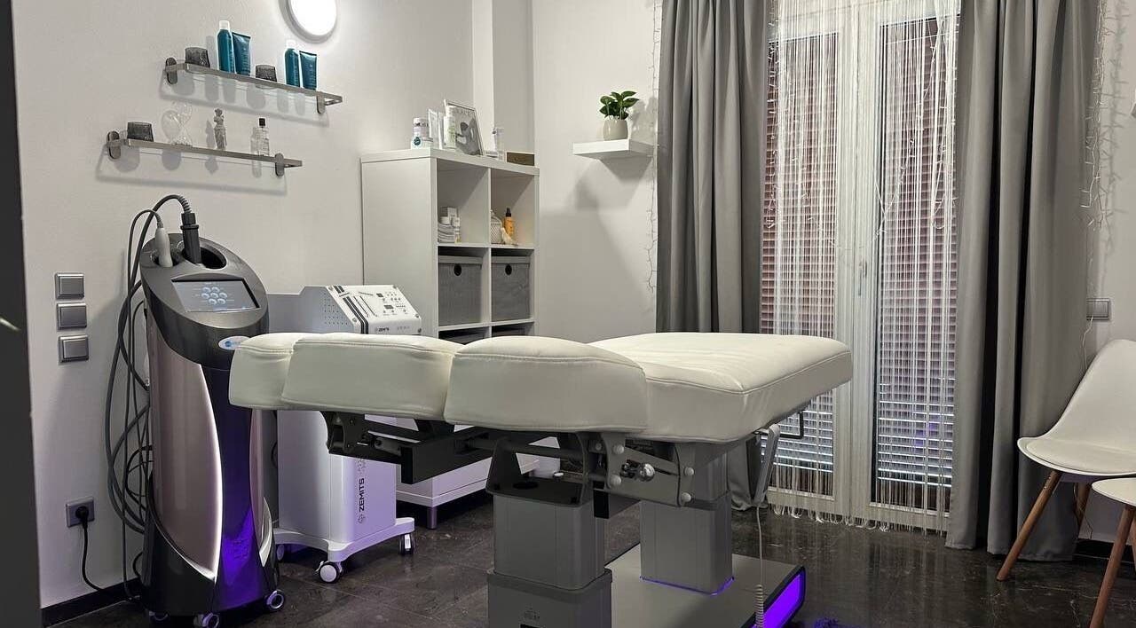 Modern treatment room at GRACE body&face, Glyfada, GR featuring a sleek massage bed and professional equipment.