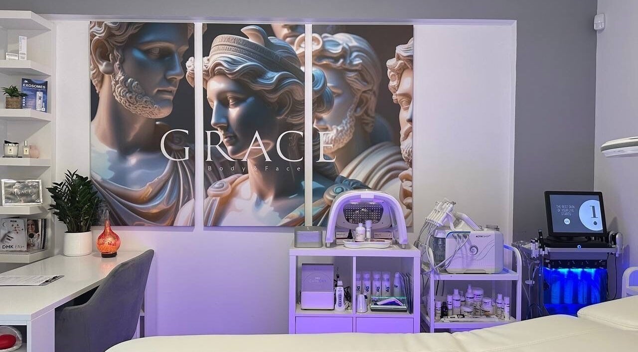 Decorated treatment room at GRACE body&face, Glyfada, GR showcasing elegant Greek-themed wall art.