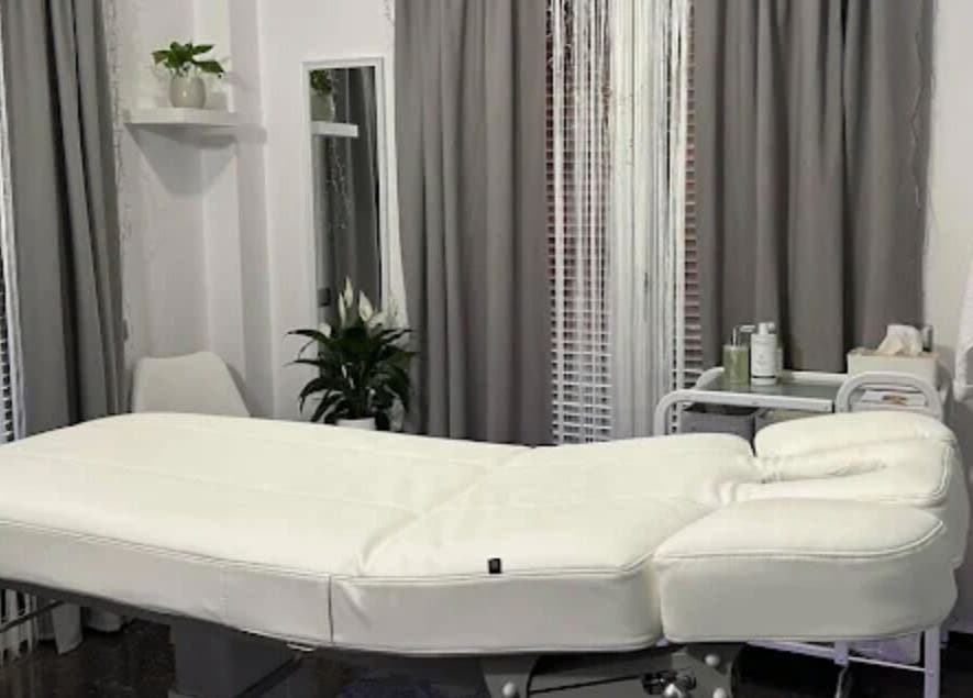 Relaxing massage room at GRACE body&face in Glyfada, GR featuring a plush treatment table and soothing decor.