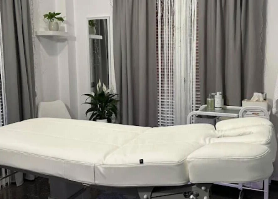 Relaxing massage room at GRACE body&face in Glyfada, GR featuring a plush treatment table and soothing decor.
