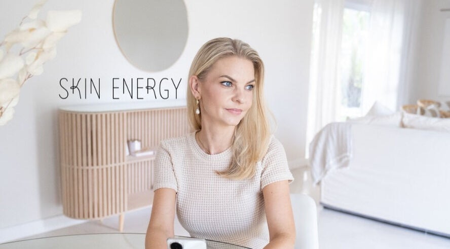 Woman sitting elegantly at Skin Energy, Cape Town, Western Cape, ZA, exuding calm and sophistication.