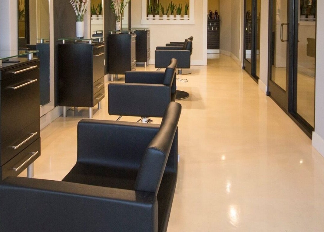 Modern salon interior at Lyna's Beauty Salon in Menlo Park, California, US, featuring sleek black chairs.