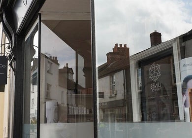 Entrance of Cortés & Co Medispa with elegant signage in Usk, Wales, GB, reflecting the serene street.