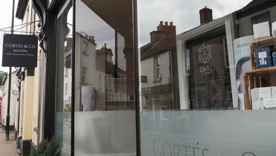 Elegant facade of Cortés & Co Medispa in Usk, Wales, GB, showcasing a stylish exterior with signage.