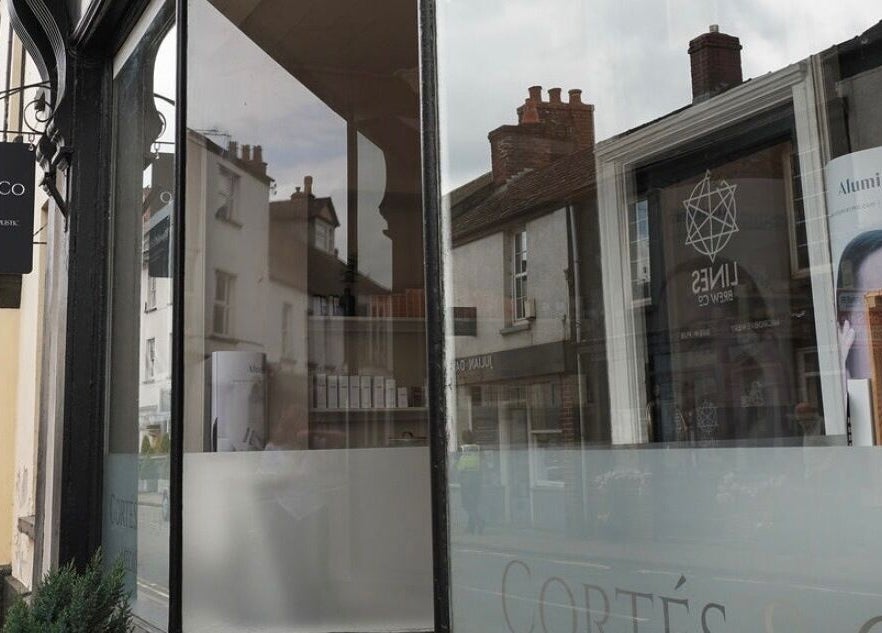 Elegant facade of Cortés & Co Medispa in Usk, Wales, GB, showcasing a stylish exterior with signage.