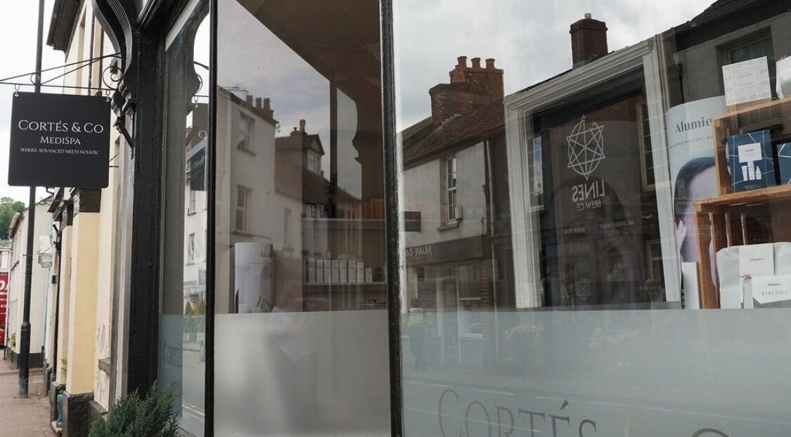 Elegant facade of Cortés & Co Medispa in Usk, Wales, GB, showcasing a stylish exterior with signage.