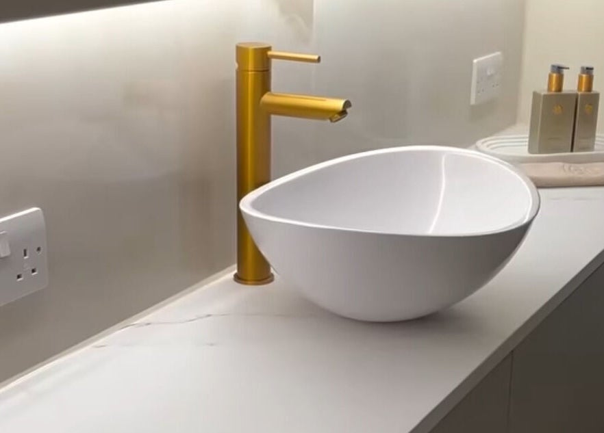 Modern sink with gold faucet at Cortés & Co Medispa, Usk, Wales, GB
