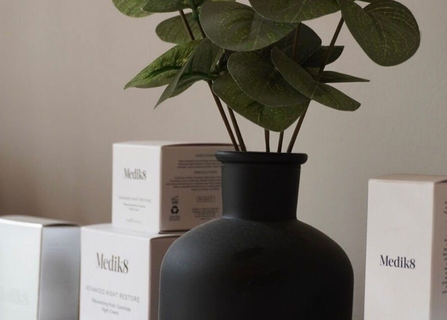 Elegant skincare display at Cortés & Co Medispa, Usk, Wales, GB featuring lush plant decor.