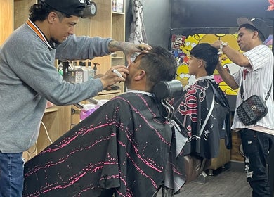 Clientes disfrutan cortes en Lex Barber, Bogotá, Bogotá, CO, con ambiente moderno y alegre.