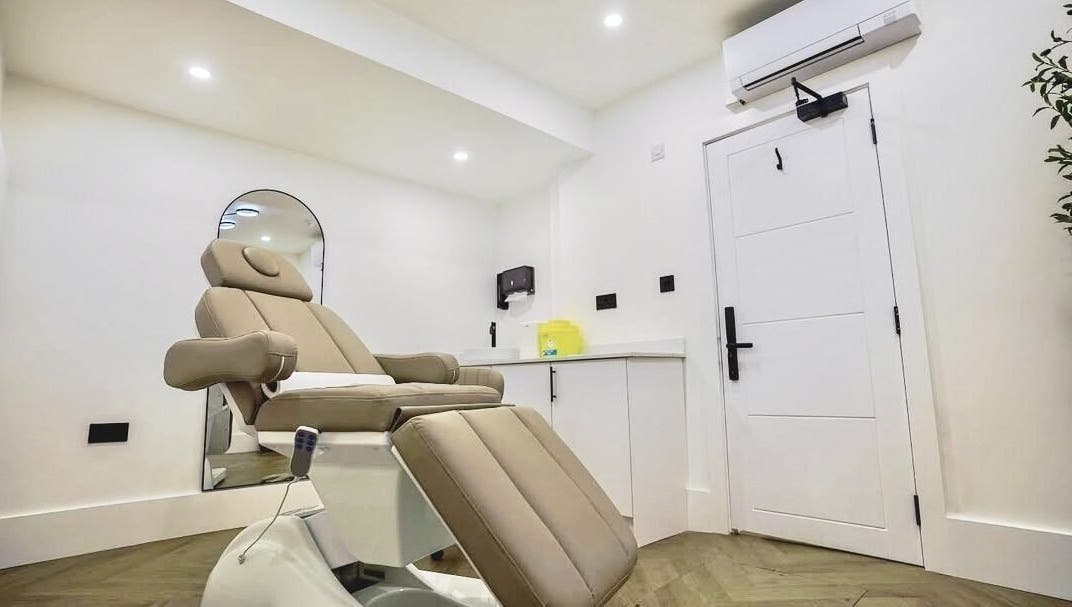 Modern treatment room at Natural Pmu, featuring a reclining chair in London, England, GB.