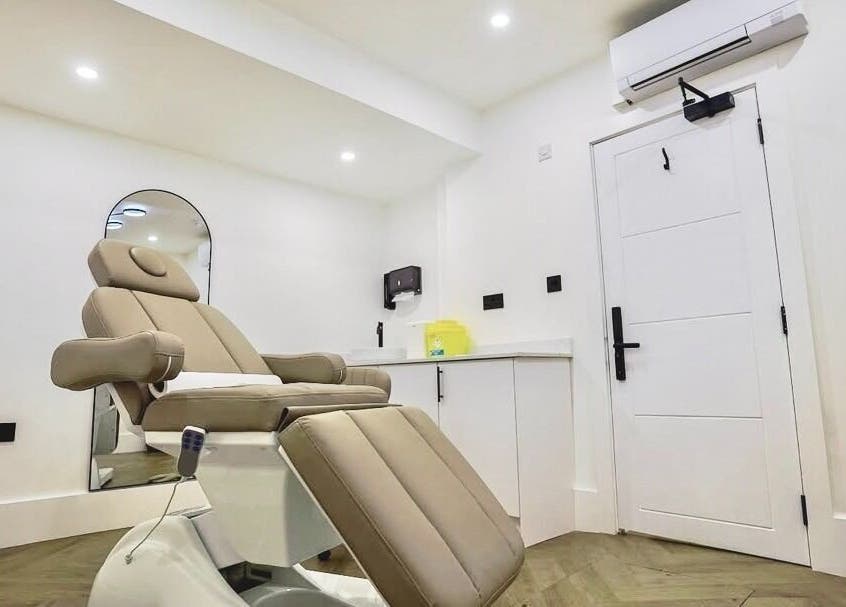 Modern treatment room at Natural Pmu, featuring a reclining chair in London, England, GB.